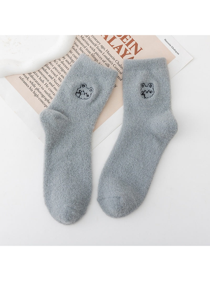 Gray fuzzy crew socks with small outlined animal-face motifs