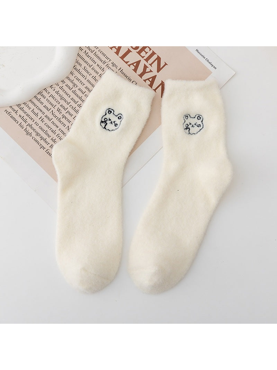 Ivory fuzzy crew socks with small outlined animal-face motifs