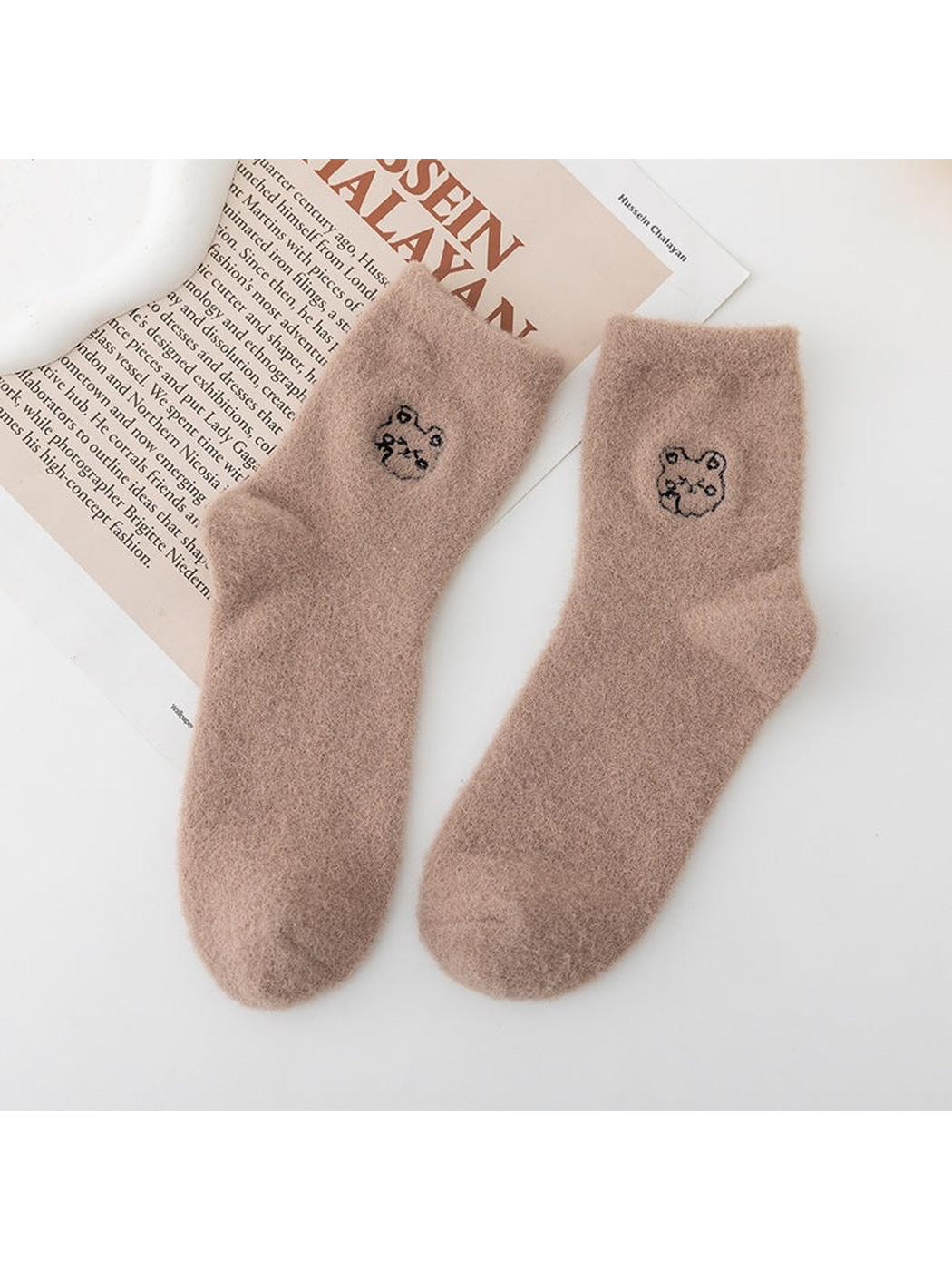 Khaki fuzzy crew socks with small outlined animal-face motifs