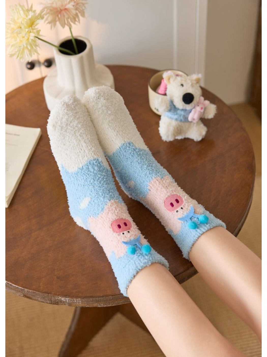 Pig Character socks worn with feet resting on a round table