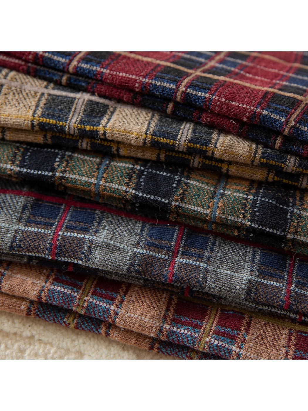 Close-up of the plaid knit patterns in multiple colors