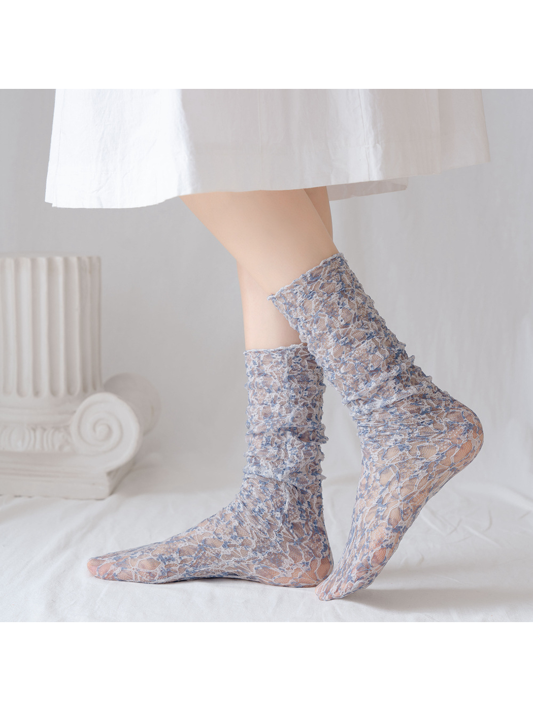 Gray Blue floral lace-mesh socks worn in a raised-heel side view
