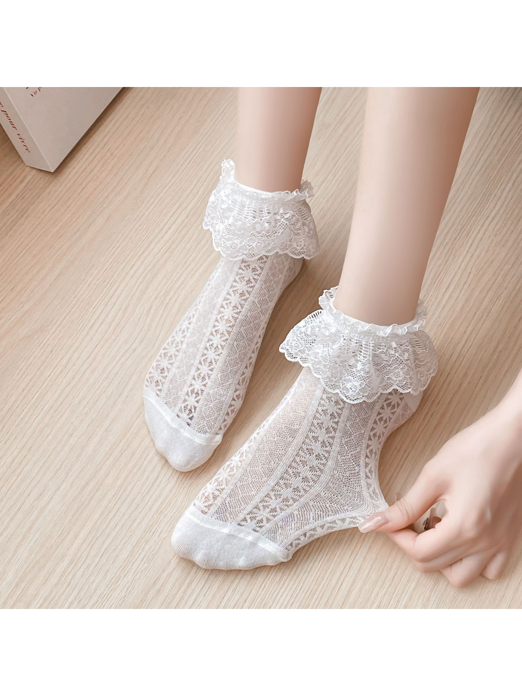 Close-up of white floral lace cuffs and openwork sock panels
