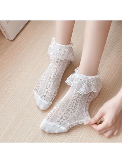 Close-up of white floral lace cuffs and openwork sock panels