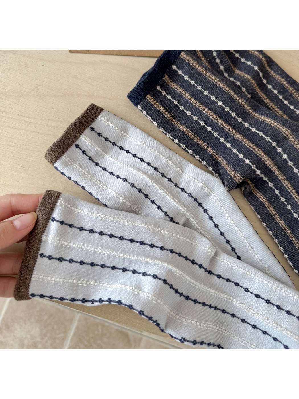 Close-up of the Light Gray and Navy striped sock texture and cuffs
