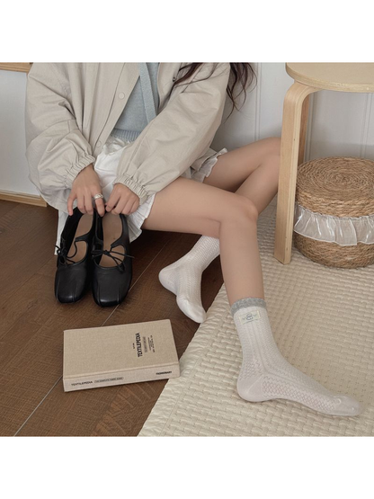 Sheep Label style white textured crew socks styled with black flats