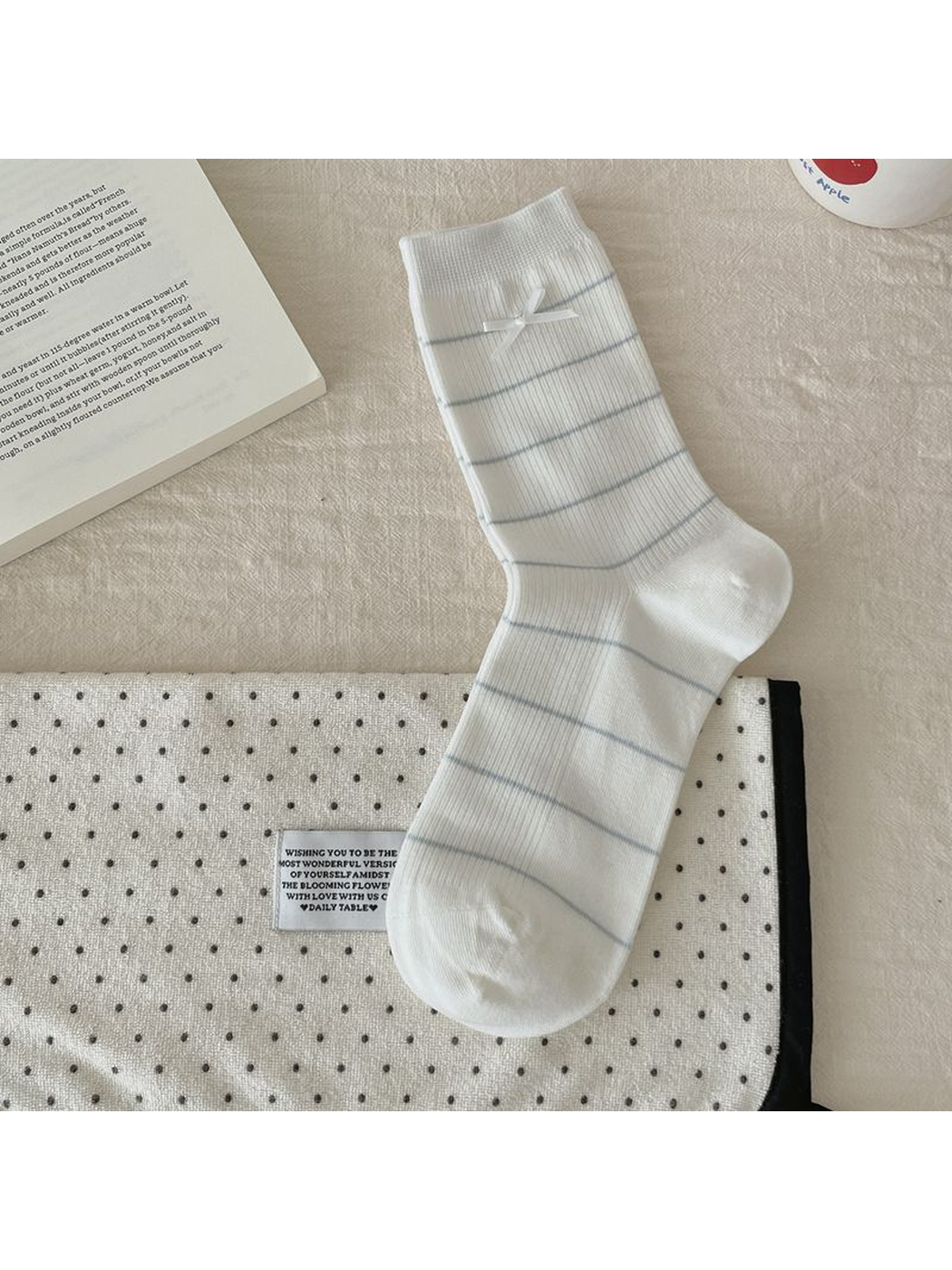 Striped Bow style white crew sock, laid flat