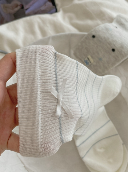 Close-up of the small bow and thin stripes on a white crew sock