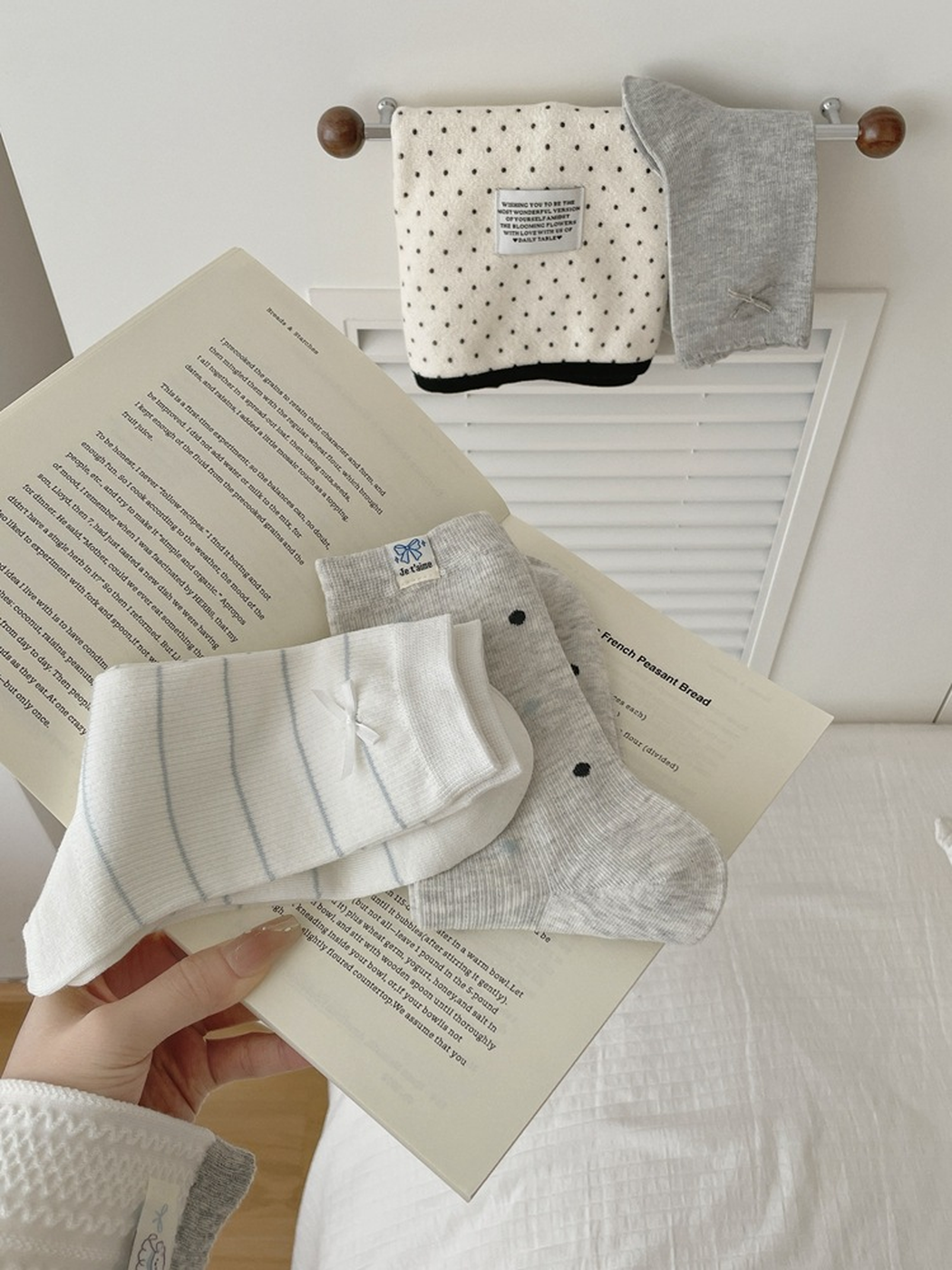 Bow, Polka Dots, Striped Bow, and Sheep Label crew sock styles displayed with an open book