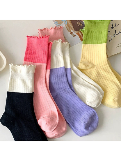 Assorted two-tone ribbed crew socks with ruffled cuffs displayed together