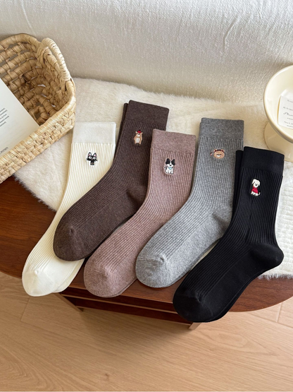 Five ribbed crew sock styles with embroidered animal motifs displayed together