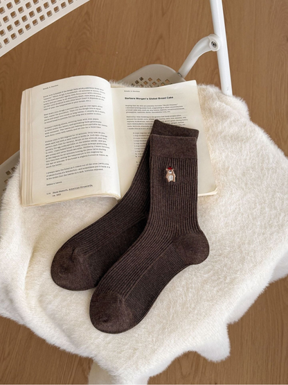 Dark Coffee ribbed crew socks with a small embroidered animal motif
