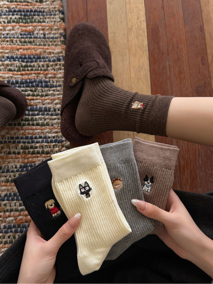 Dark Coffee embroidered crew socks worn with four additional styles displayed by hand
