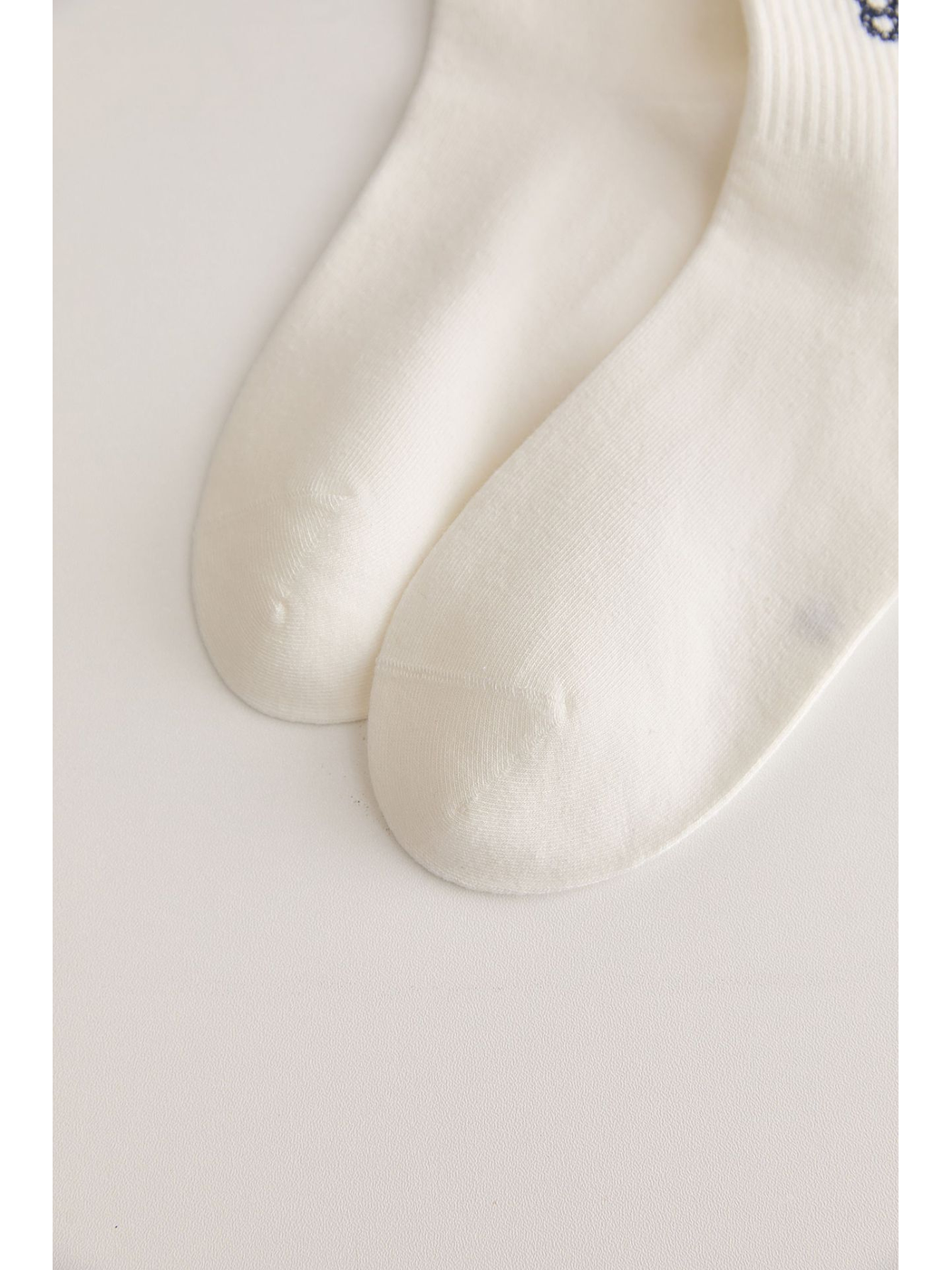 Close-up of the closed toes on ivory crew socks