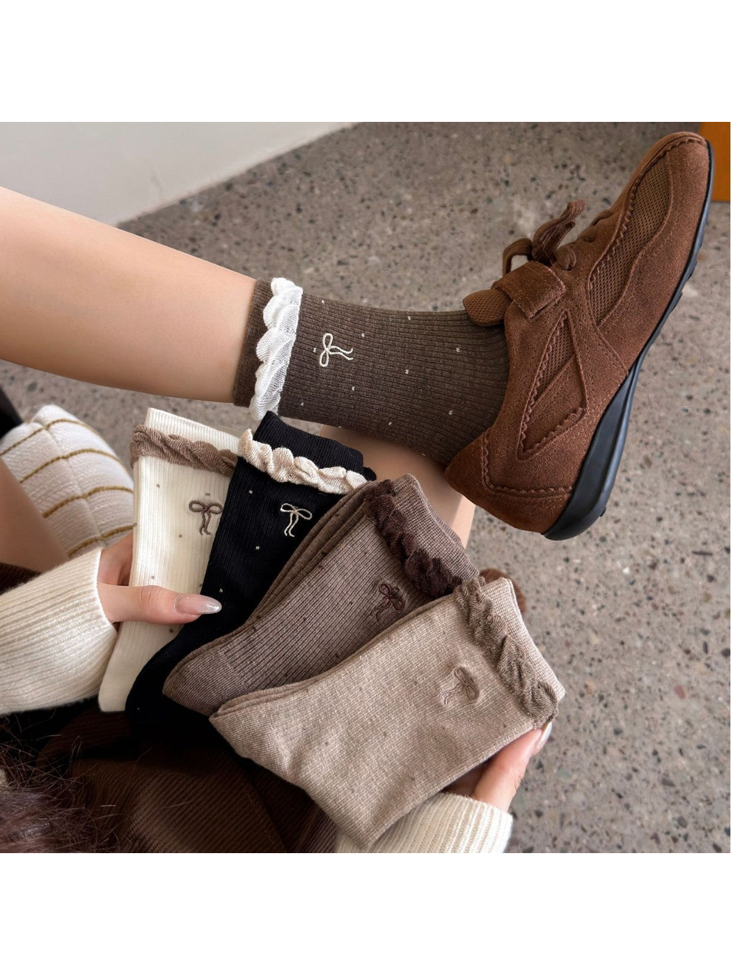 Multiple sock colors displayed together with dotted bow and ruffled cuff details