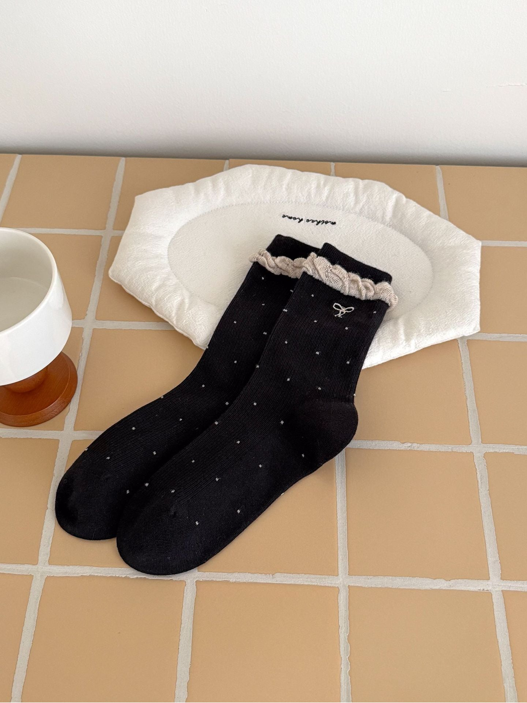 Black dotted socks with embroidered bow and contrast ruffled cuffs