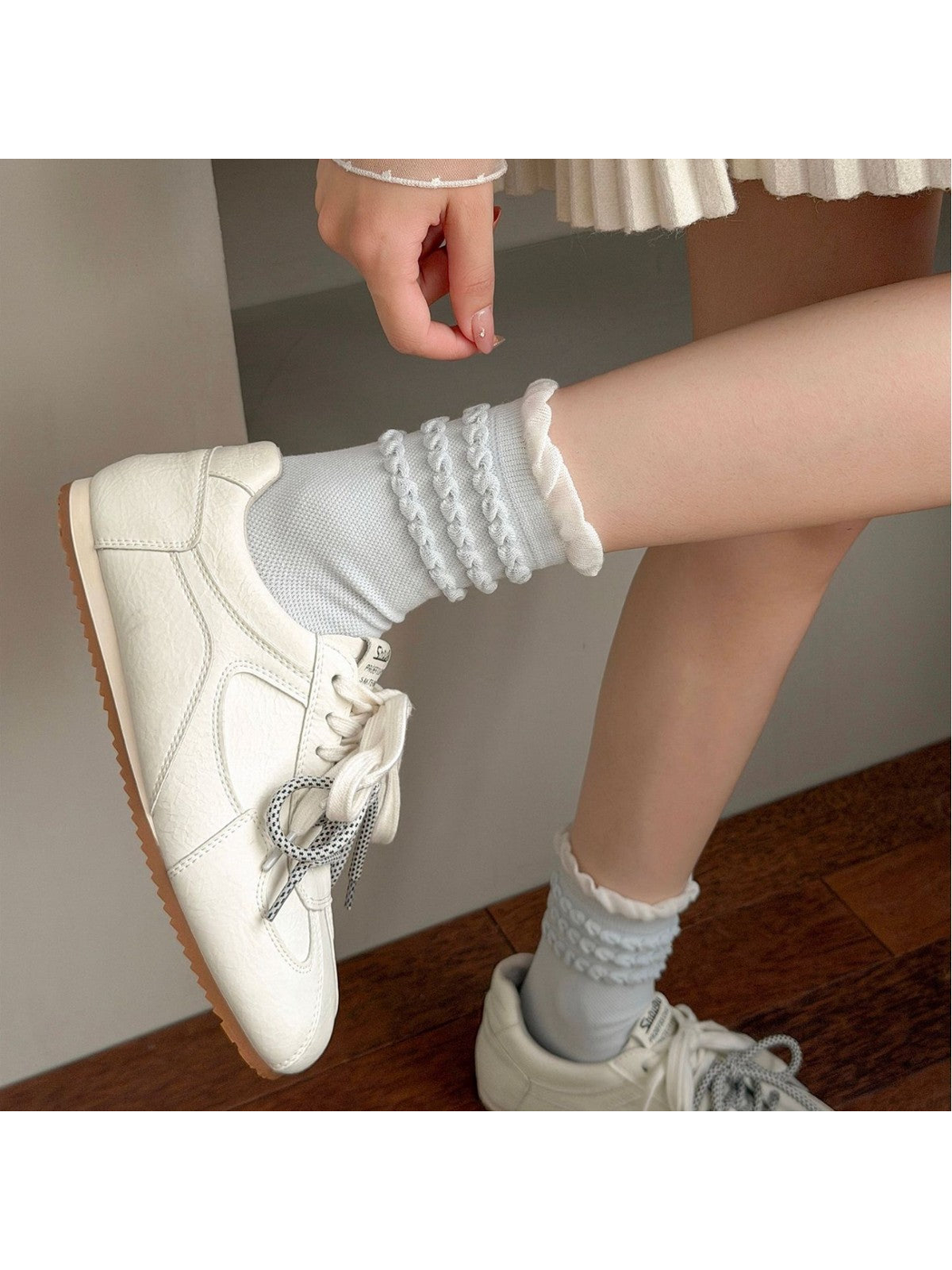 Light blue Triple Loop socks styled with white sneakers