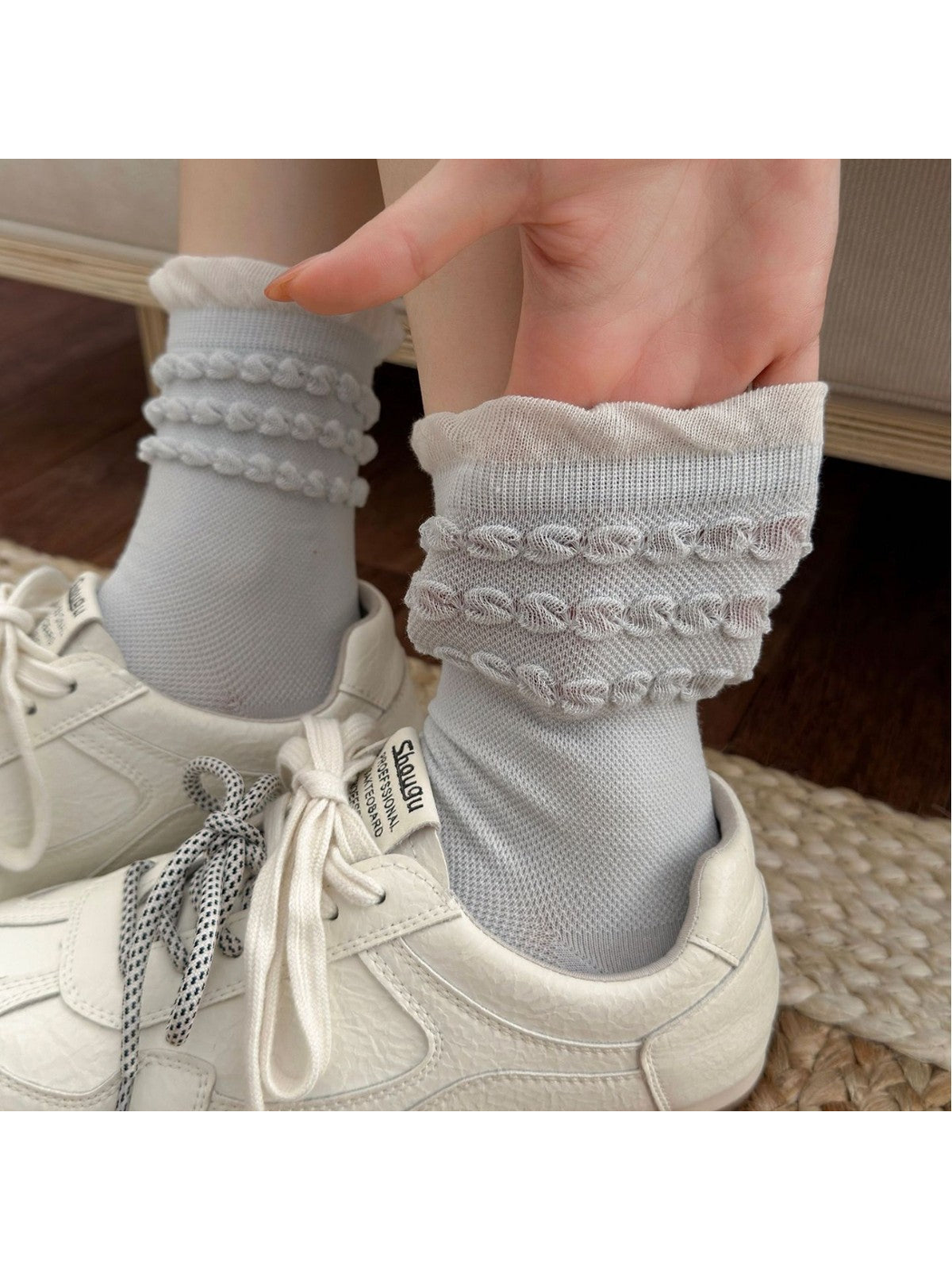 Close-up of light blue Triple Loop socks with a contrasting ruffled cuff