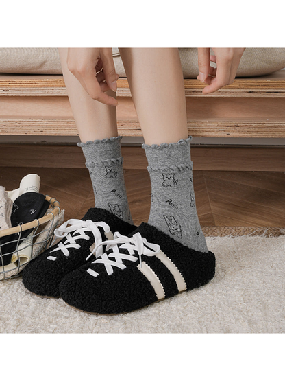 Dark gray cartoon dog crew socks worn with black slippers