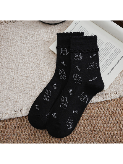 Black crew socks with cartoon dog pattern and ruffled cuffs