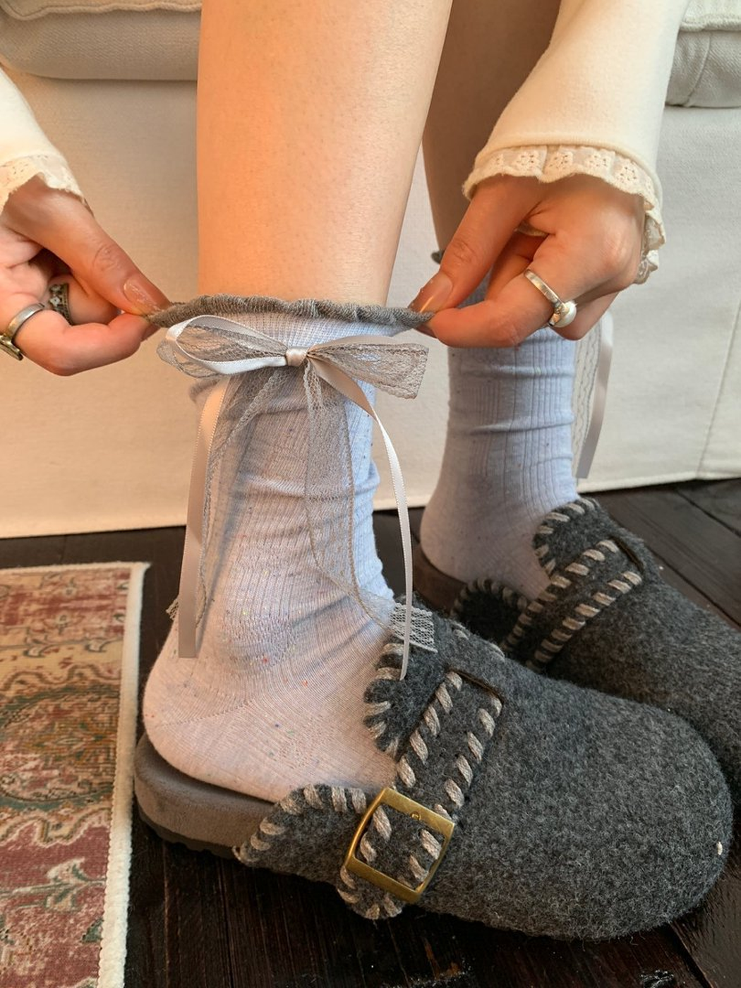 Blue Cat crew socks worn with gray felt slippers