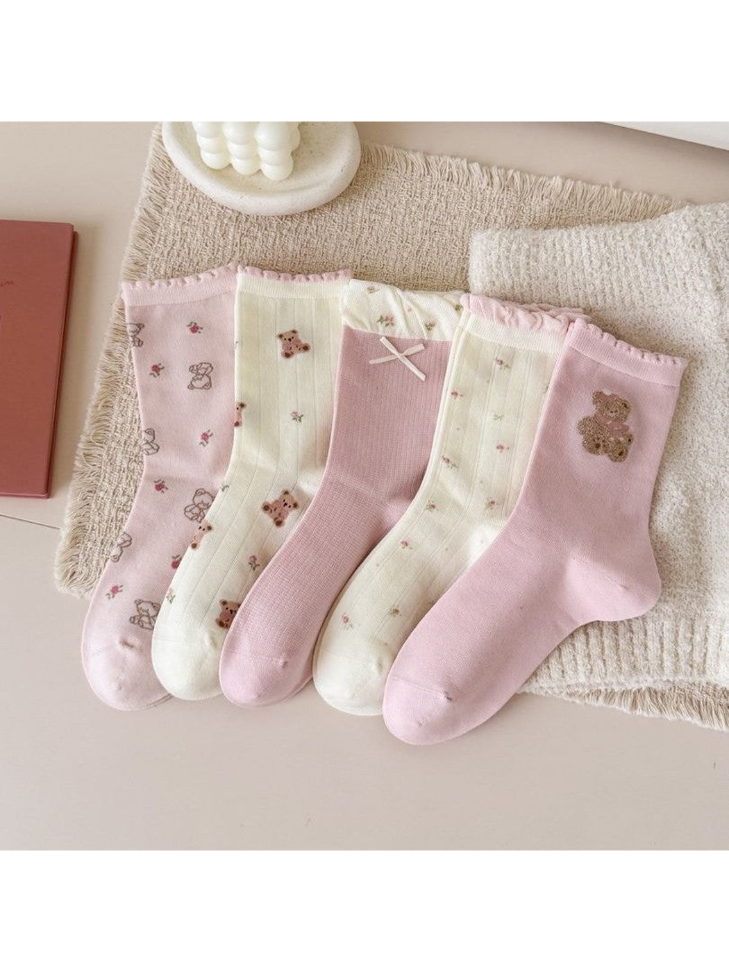 Five pink and ivory crew sock styles with ruffled cuffs displayed together