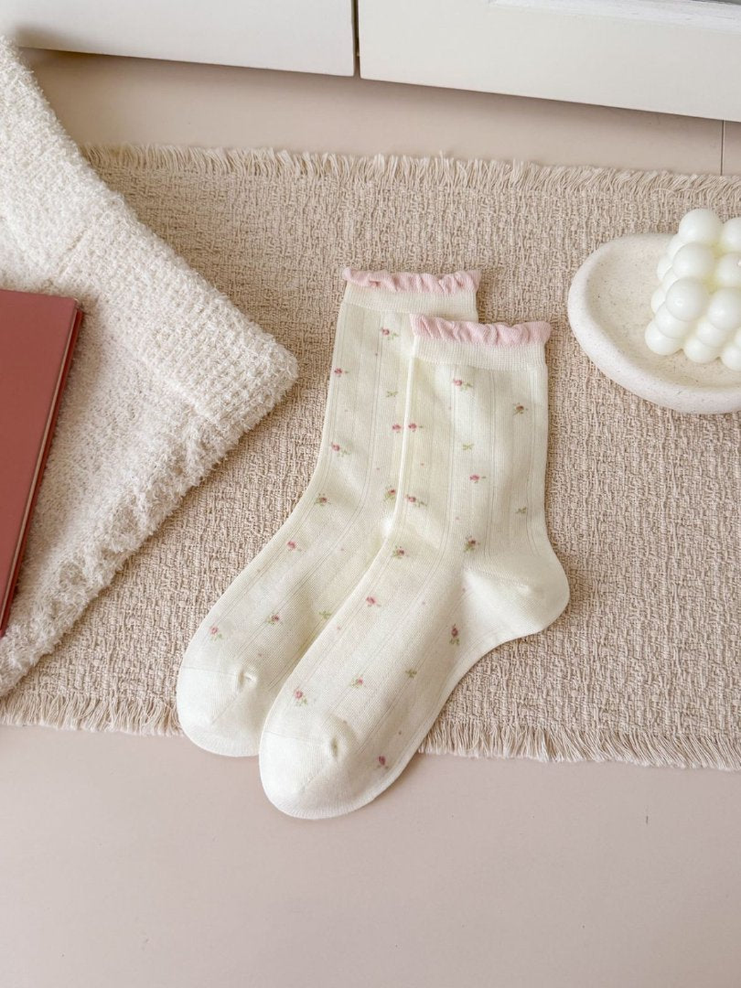 Ivory crew socks with small floral sprigs and pink ruffled cuffs