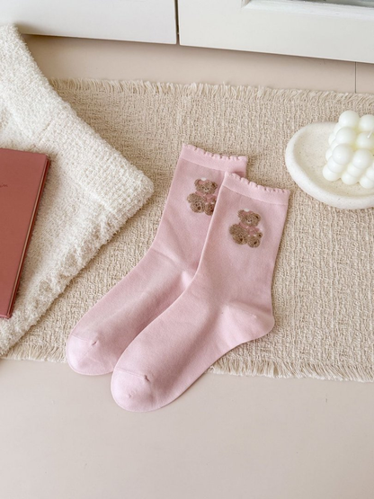 Light pink crew socks with embroidered teddy bears and ruffled cuffs