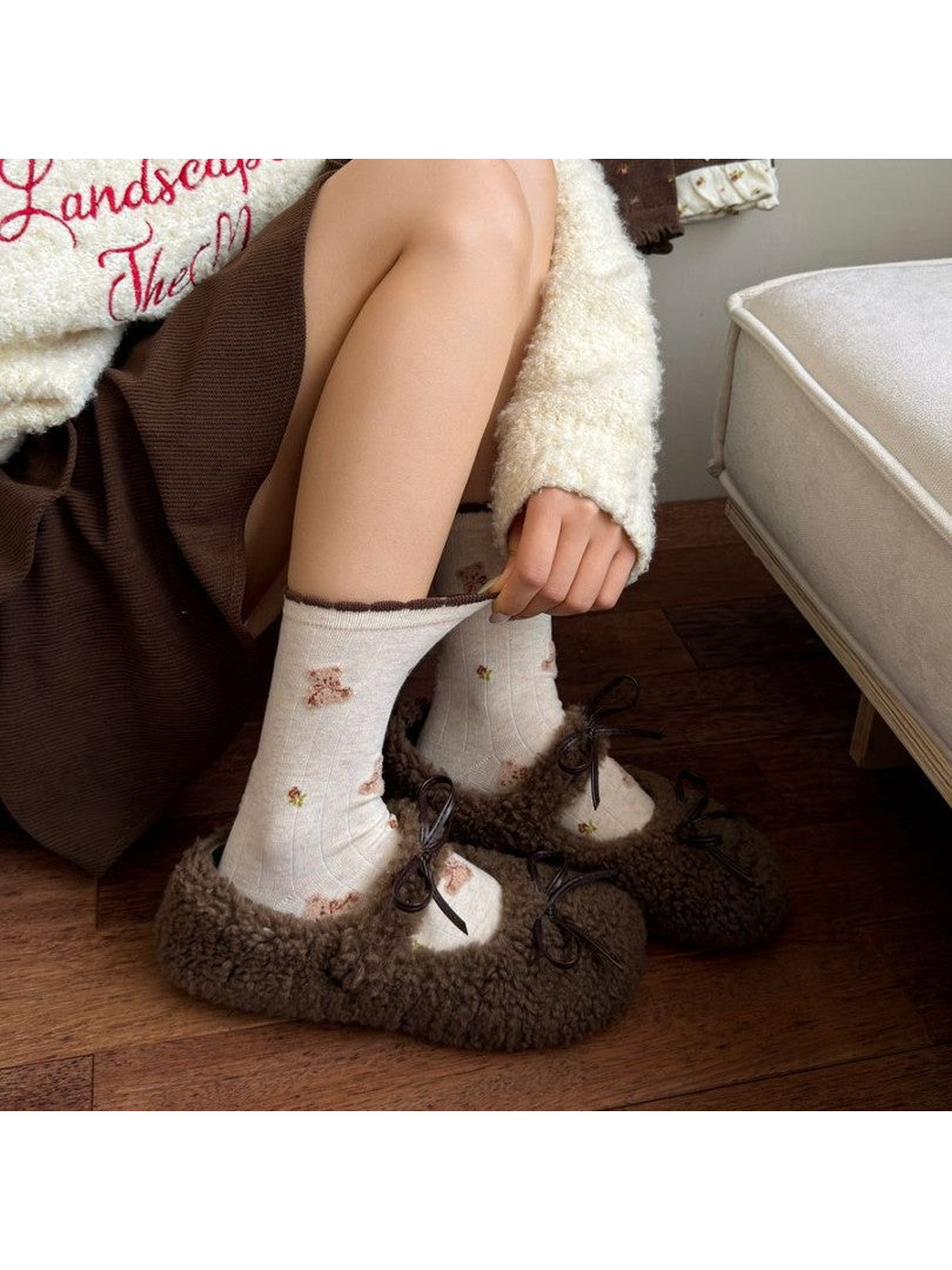 Tiny Bears socks worn with brown fuzzy-look slippers