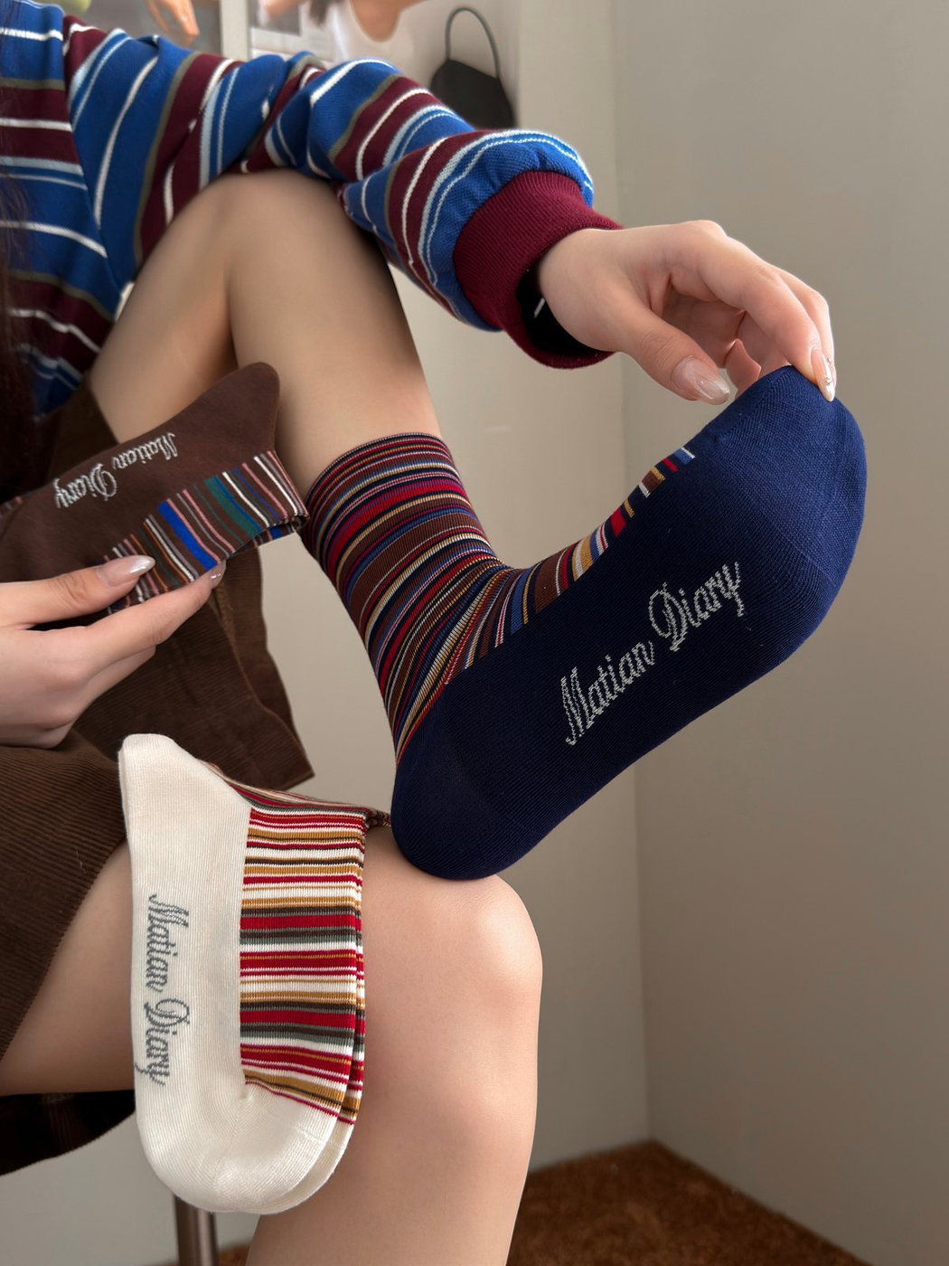 Navy striped crew sock worn with Beige and Brown color samples