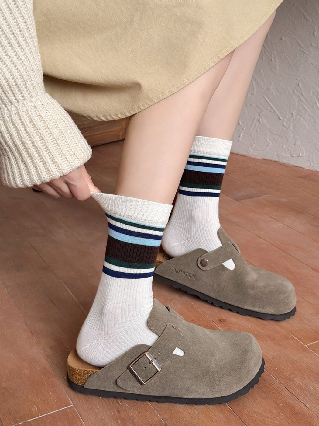 Close worn view of Wide Stripes ivory crew socks with clogs