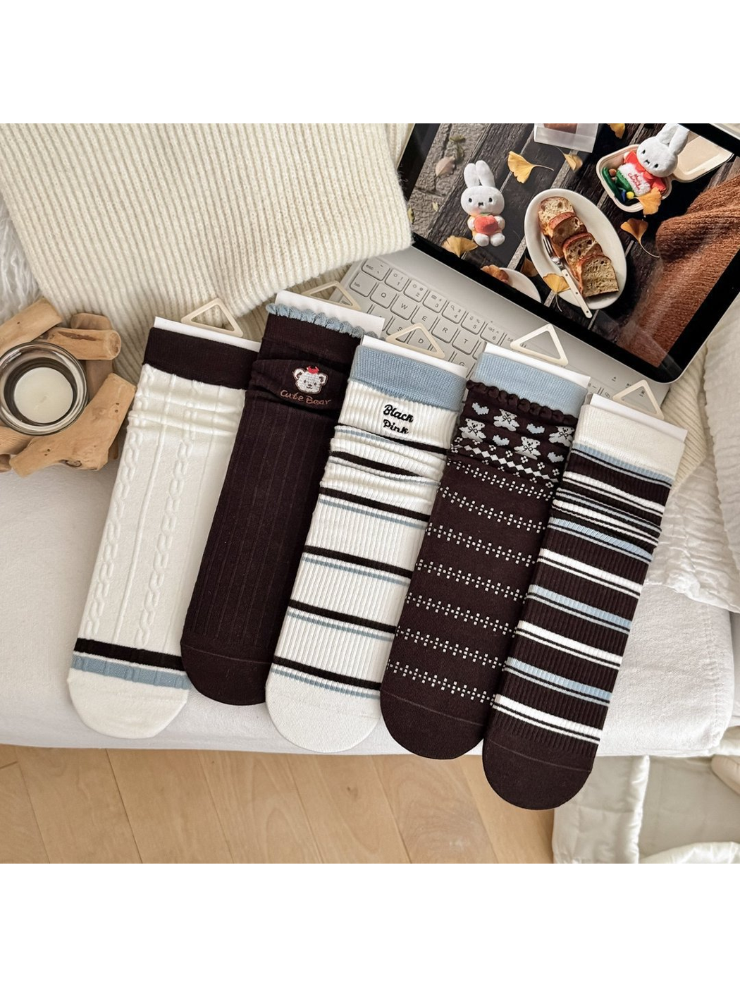 Five crew sock styles displayed together in white, dark brown and light blue