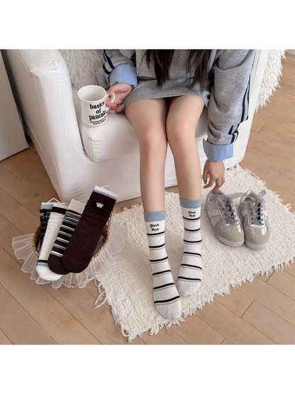 Light Stripes crew socks styled without shoes beside the five sock designs
