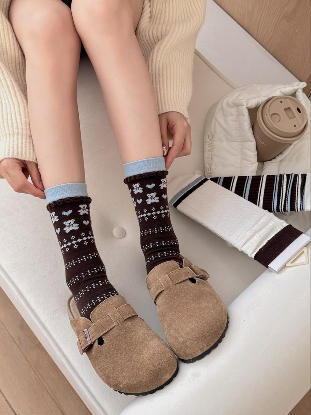Bear crew socks worn with brown clogs, with Cable and Dark Stripes designs beside them