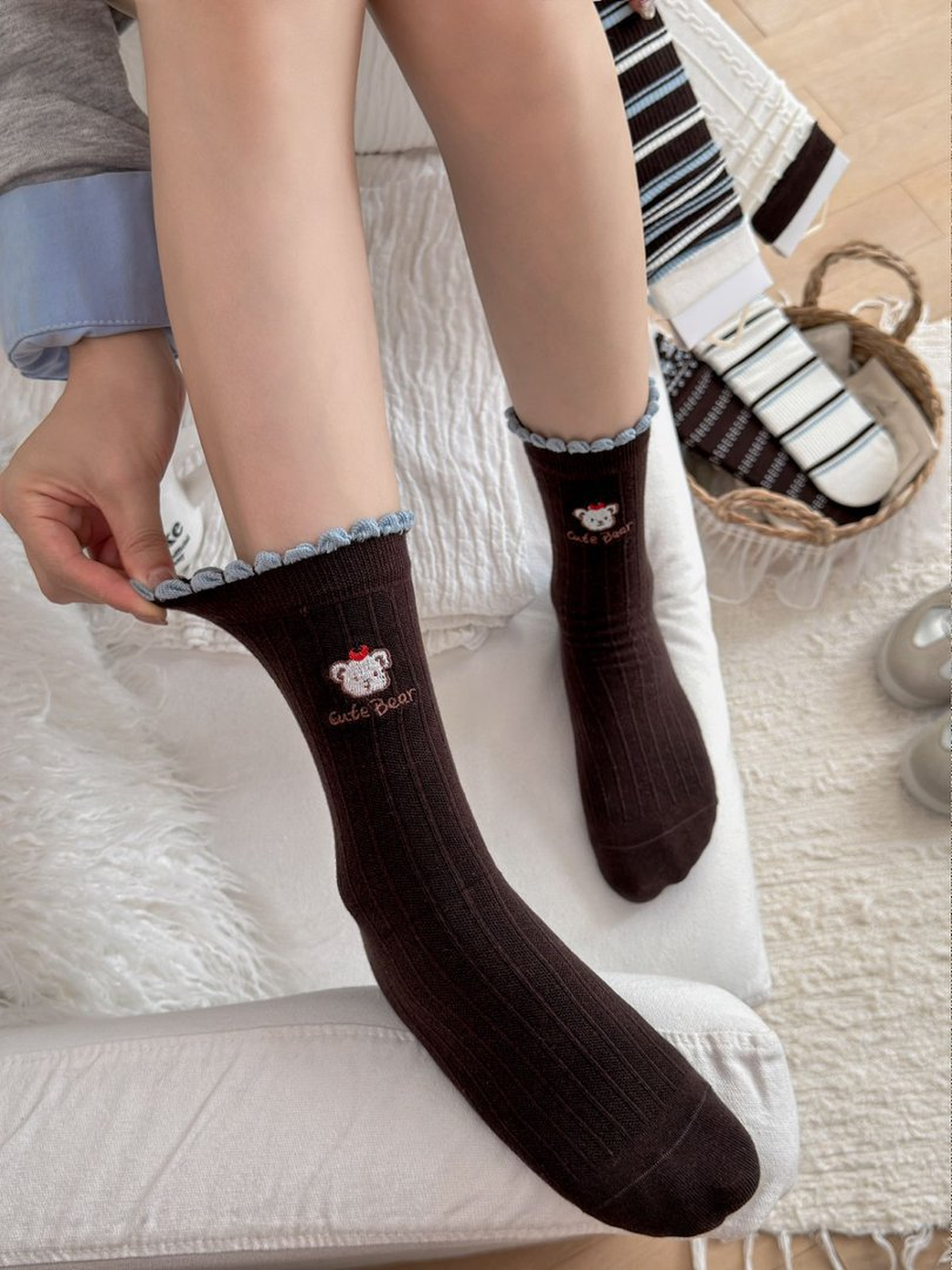 Close view of dark brown Embroidered Bear crew socks with ribbing and light-blue scalloped trim