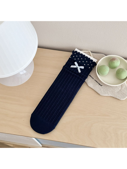 Bow style navy ribbed crew sock with light blue bow and dotted scalloped cuff
