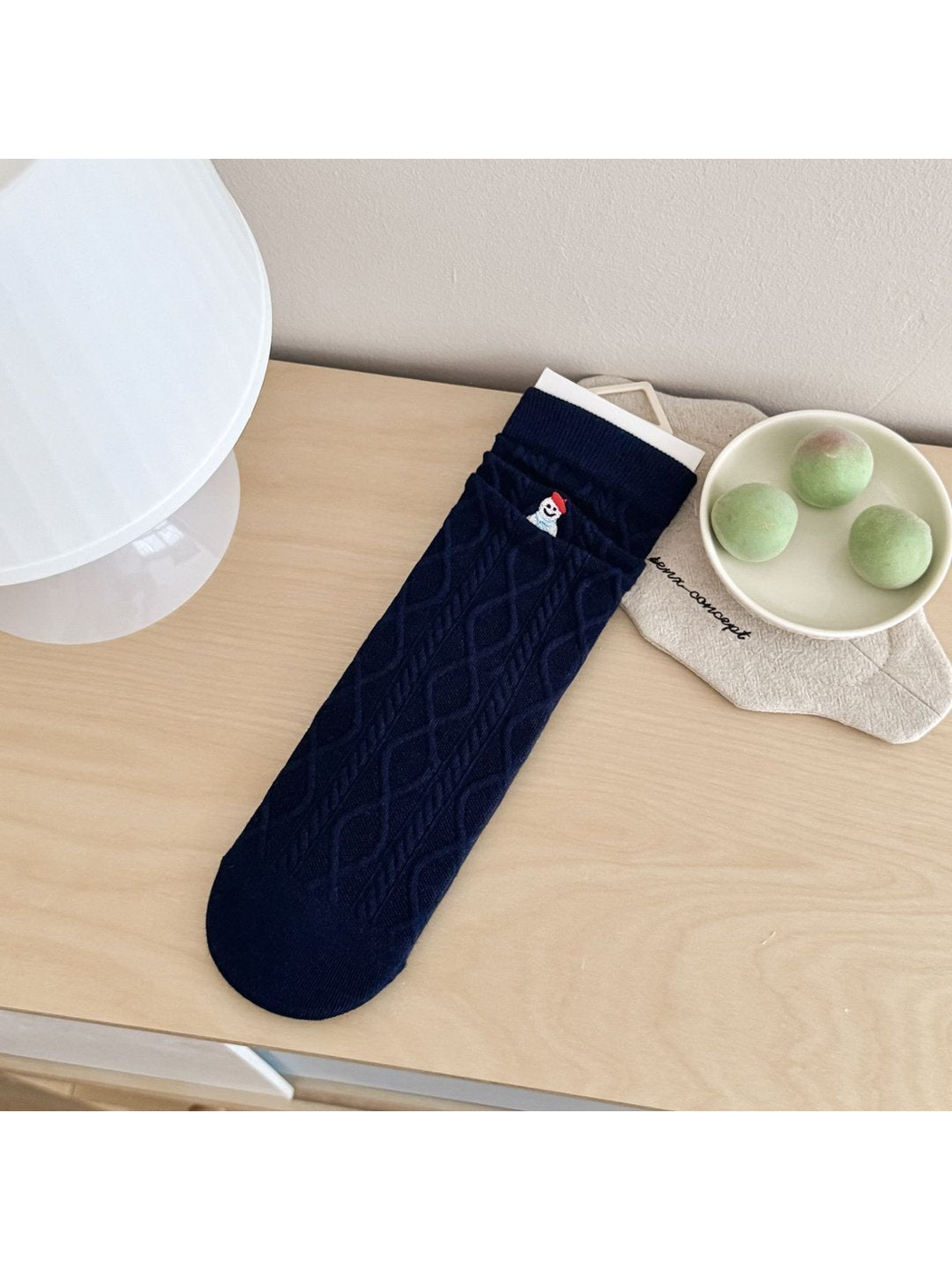 Snowman style navy crew sock with cable-knit diamond texture and embroidered snowman