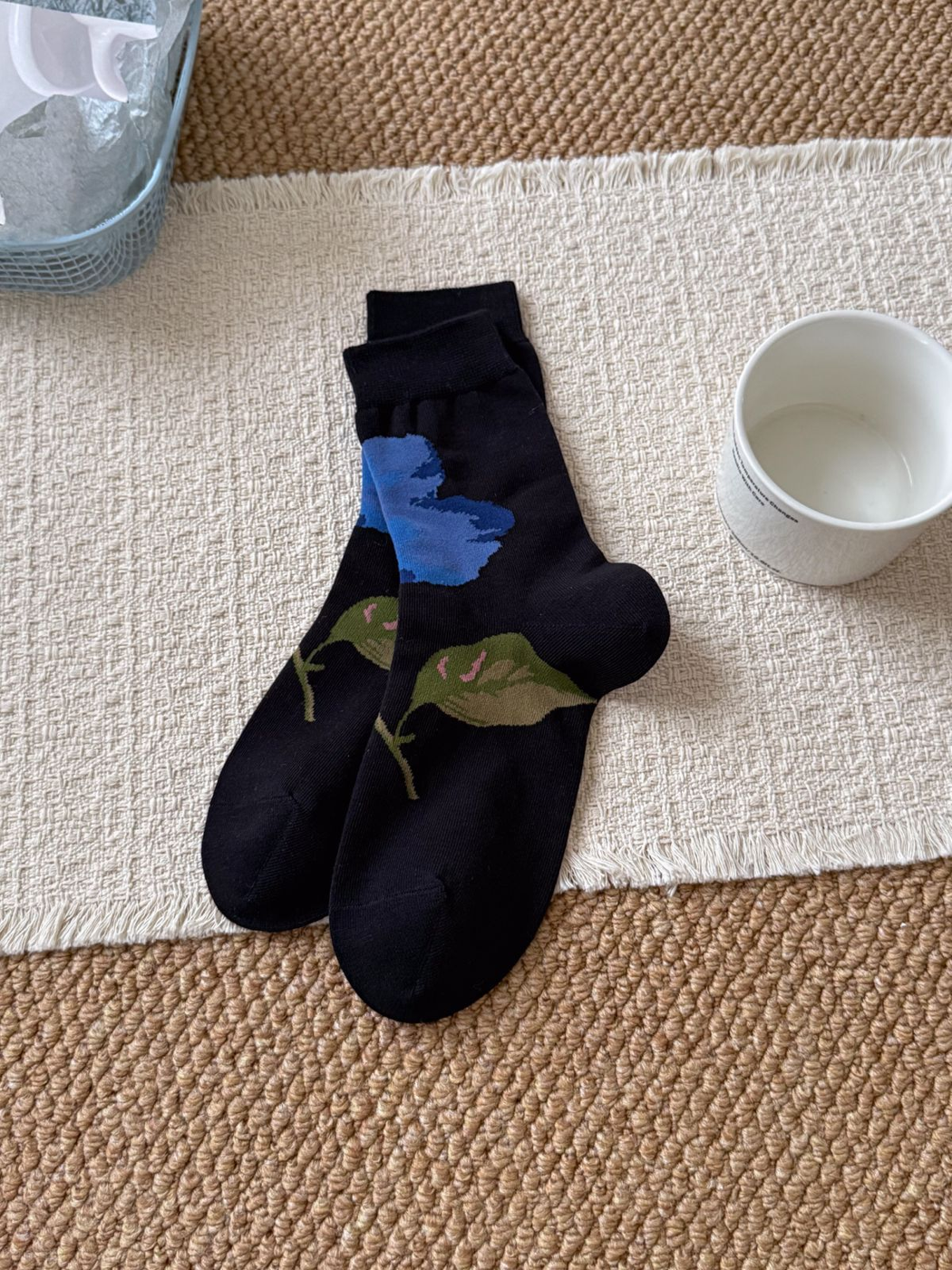 Painterly Floral black crew socks with a blue flower and green leaves