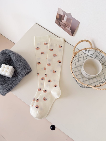 Ivory mid-calf socks with repeating peach bear-face motifs
