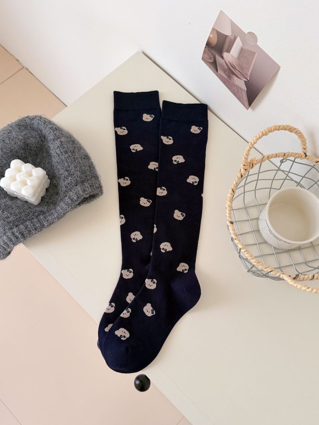 Navy mid-calf socks with repeating pale bear-face motifs