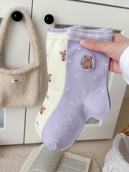 Lavender Polka Bear and ivory Teddy Floral socks held together