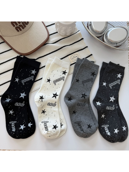 Black, ivory, dark gray and light gray crew socks with stars, speckles and script lettering