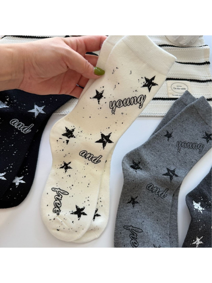 Ivory star-print crew socks held beside black and gray color options