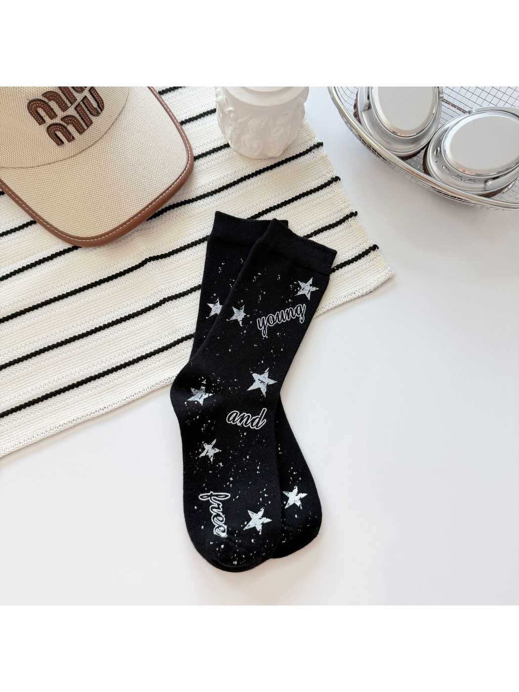 Black crew socks with white stars, speckles and script lettering
