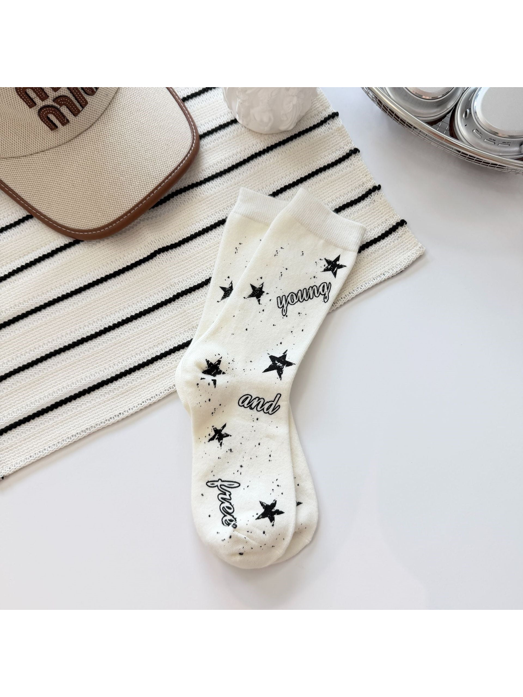Ivory crew socks with black stars, speckles and script lettering