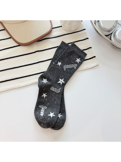 Dark gray crew socks with white stars, speckles and script lettering