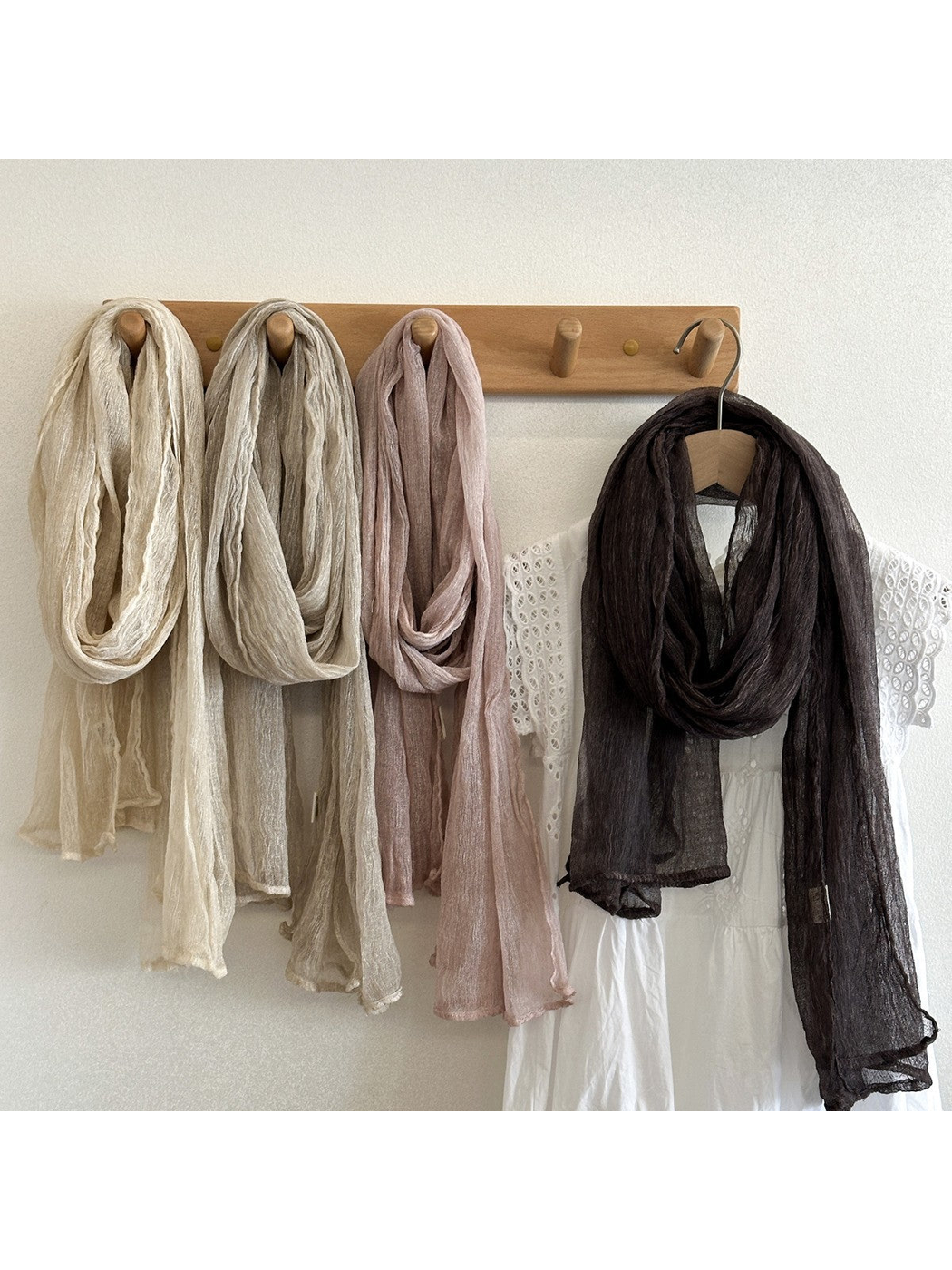 Cream, khaki, light pink and dark brown crinkled scarves displayed together