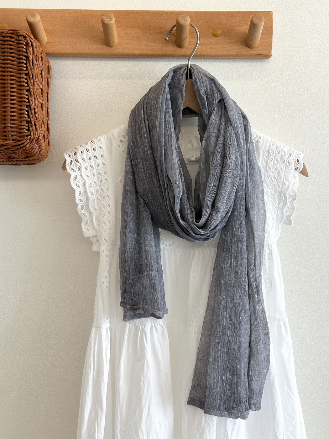 Gray Blue crinkled scarf draped over a white eyelet dress
