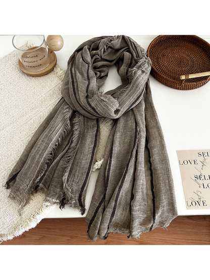 Dark Brown striped scarf arranged on a tabletop with woven accents