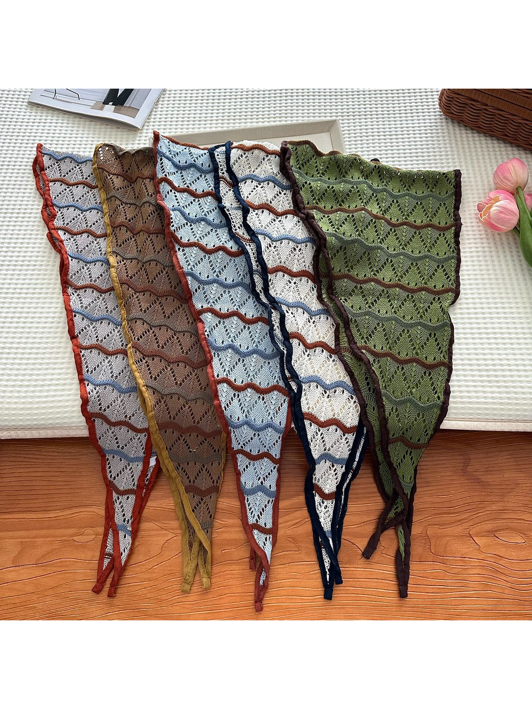 Five openwork triangle scarf colors arranged flat to show their patterns and pointed ends